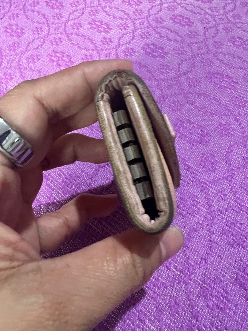 Christian Dior Key Holder (Category: Luxury Bags & Wallets) located in Quezon City. Submitted by kayesantos7 (Listing ID 1398392571, Image 1). Description: - Authentic Christian Dior key holder - Features the iconic pink and beige Dior Oblique pattern - Adorned with a bow detail and 'D' charm - Interior crafted from pink leather - Includes key hooks Selling my Christian Dior trotter pink keycase. In good preloved condition. Has signs of usage alr