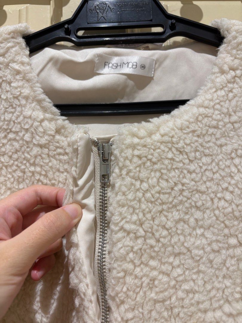 Jacket (Category: Coats, Jackets and Outerwear) located in Puchong. Submitted by silverturtle_376ccc (Listing ID 1398478364, Image 3). Description: - FASHMOB cream-colored cropped jacket - Size: xs - Features: - Round neckline - Two front pockets - Button closures - Long sleeves with buttoned cuffs - Material: Soft, teddy bear-like fabric.