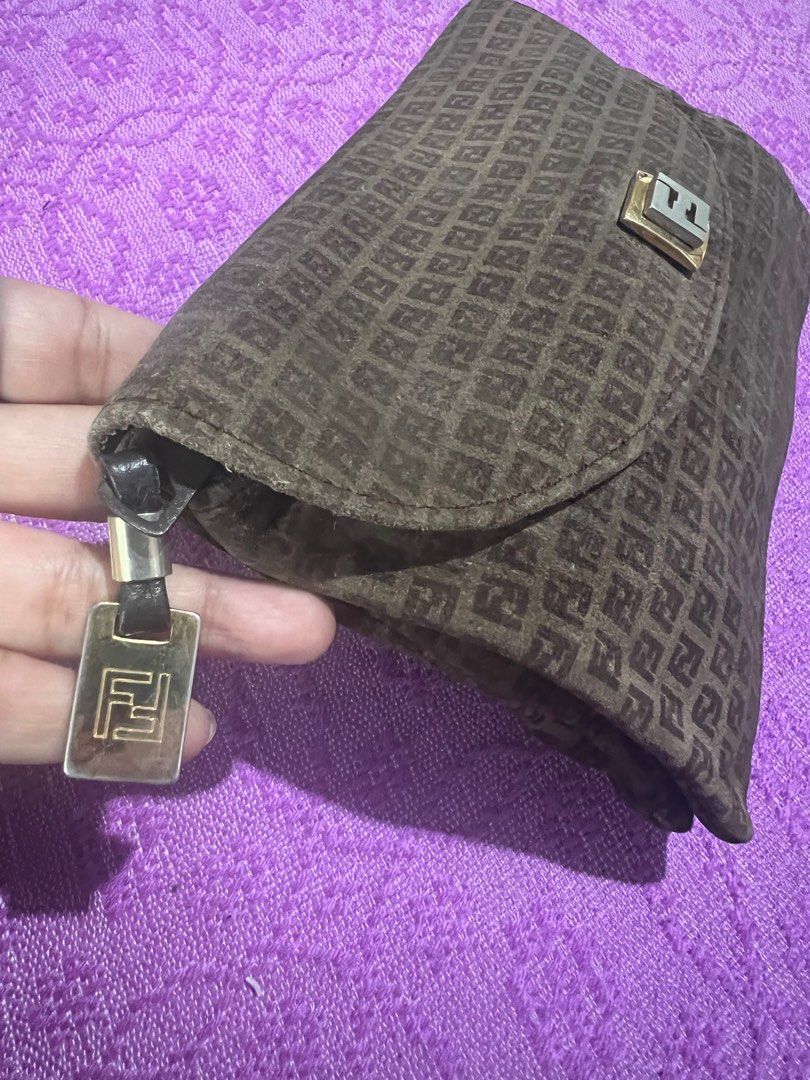 Fendi Clutch Bag (Category: Luxury Bags & Wallets) located in Quezon City. Submitted by kayesantos7 (Listing ID 1398379857, Image 3). Description: - Super Sale!!!! Authentic Fendi clutch bag - Features the iconic FF logo pattern - Leather interior - Gold-tone metal clasp - Zipper with logo charm - Made in Italy - Serial number: 77226 Selling my vintage Fendi clutch/wallet. Buttery-soft material. Gold tone clasp has already faded. Such a nice coll