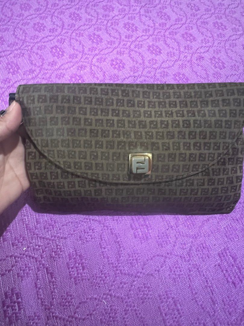 Fendi Clutch Bag (Category: Luxury Bags & Wallets) located in Quezon City. Submitted by kayesantos7 (Listing ID 1398379857, Image 2). Description: - Super Sale!!!! Authentic Fendi clutch bag - Features the iconic FF logo pattern - Leather interior - Gold-tone metal clasp - Zipper with logo charm - Made in Italy - Serial number: 77226 Selling my vintage Fendi clutch/wallet. Buttery-soft material. Gold tone clasp has already faded. Such a nice coll