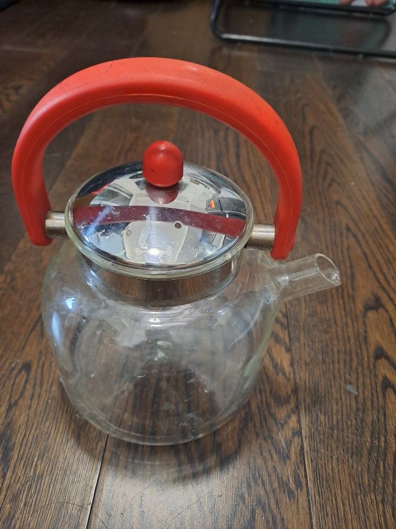 Glass Teapot with Red Handle (Category: Coffee & Tea Tableware) located in Manila. Submitted by joanbalde39643 (Listing ID 1398366256, Image 2). Description: - Glass teapot with red handle and lid knob - Clear glass body - Silver-colored rim and lid - Curved spout for easy pouring - Perfect kitchen addition.