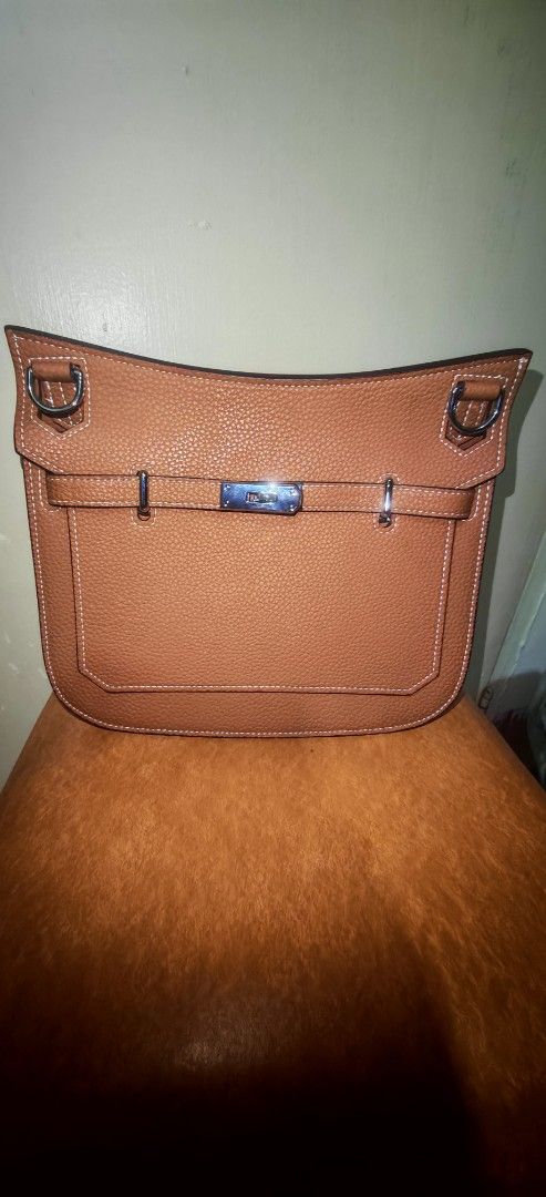 Hermes Shoulder Bag (Category: Luxury Bags & Wallets) located in Imus. Submitted by nikv.omcly (Listing ID 1398404206, Image 2). Description: - Tan shoulder bag - Flap closure - Includes dust bag, lock, and key - Textured leather exterior - White stitching details - Matching tan interior Rfs decluttering. Di nagamit simula nung na purchase fresh in and out po..