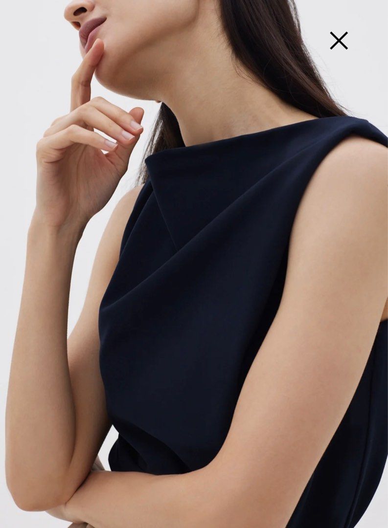 Lindea Drape Shell Top (2022 Version) (Category: Sleeveless) located in Singapore. Submitted by justsell1234 (Listing ID 1398522255, Image 2). Description: - Navy sleeveless top - Unique draped neckline - Flattering silhouette - Suitable for work and casual wear - Back zipper closure - Versatile wardrobe piece.