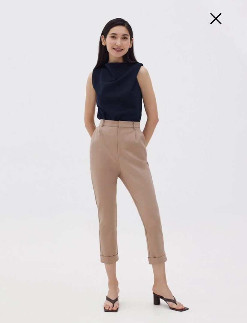 Lindea Drape Shell Top (2022 Version) (Category: Sleeveless) located in Singapore. Submitted by justsell1234 (Listing ID 1398522255, Image 3). Description: - Navy sleeveless top - Unique draped neckline - Flattering silhouette - Suitable for work and casual wear - Back zipper closure - Versatile wardrobe piece.