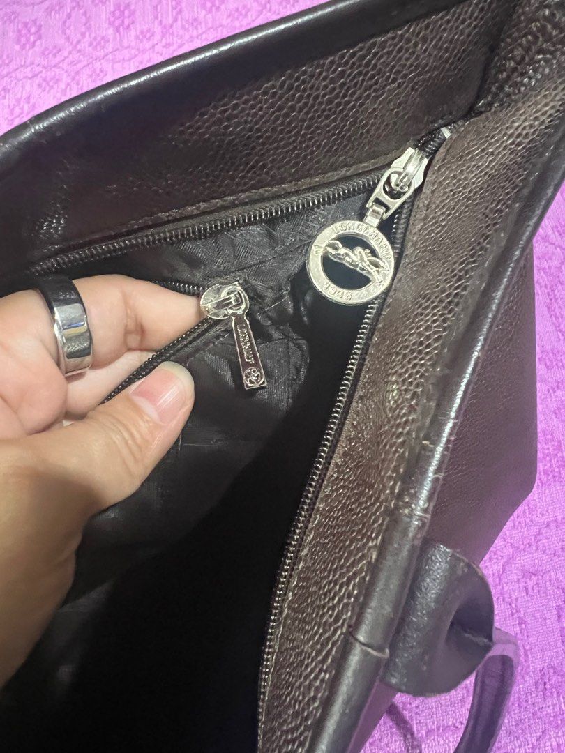 Longchamp Leather Tote Bag (Category: Luxury Bags & Wallets) located in Quezon City. Submitted by kayesantos7 (Listing ID 1398375913, Image 2). Description: - Authentic Longchamp tote bag - Rich brown color, All-leather Bag - Secure zip closure - Interior pocket for organization - Durable leather exterior with textured finish - Comfortable double handles - Iconic Longchamp logo detail.