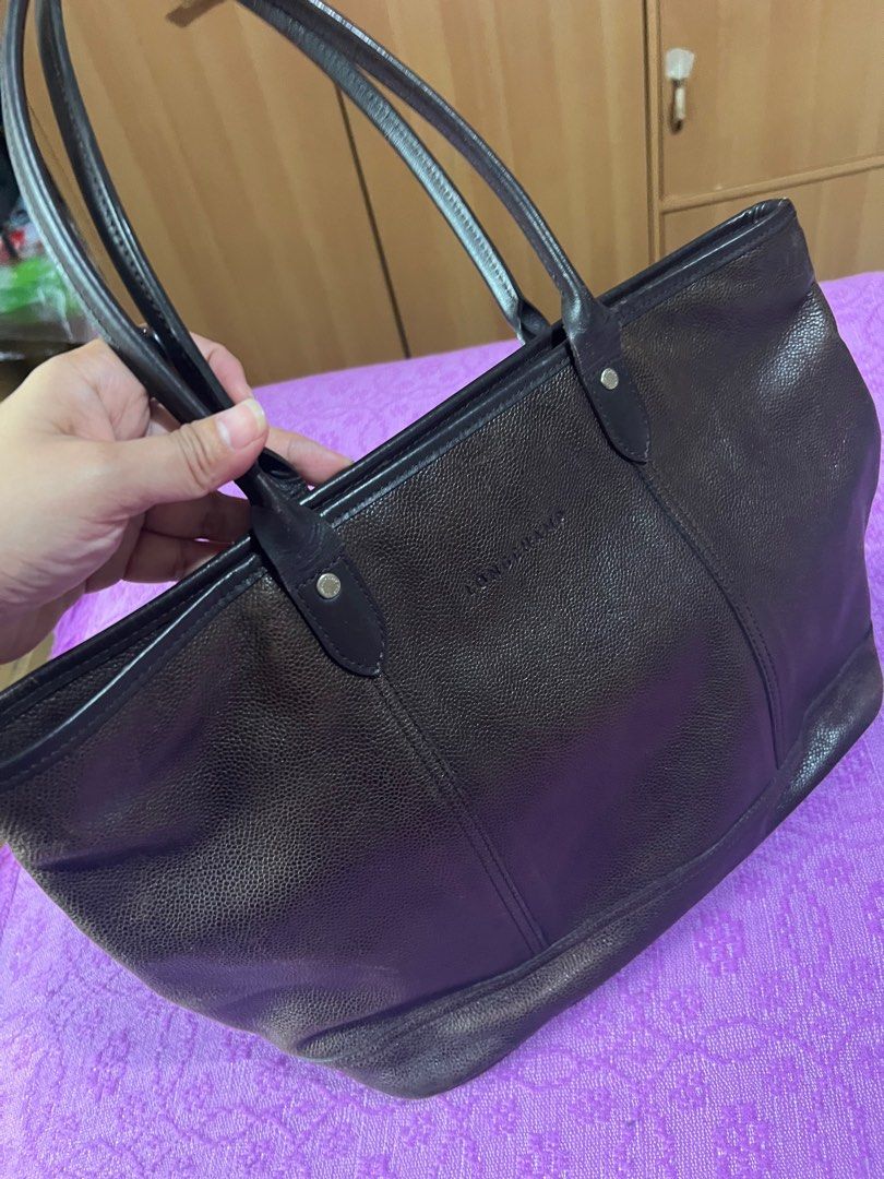 Longchamp Leather Tote Bag (Category: Luxury Bags & Wallets) located in Quezon City. Submitted by kayesantos7 (Listing ID 1398375913, Image 3). Description: - Authentic Longchamp tote bag - Rich brown color, All-leather Bag - Secure zip closure - Interior pocket for organization - Durable leather exterior with textured finish - Comfortable double handles - Iconic Longchamp logo detail.