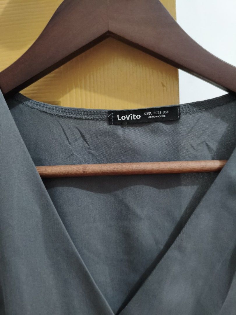 Lovito Gray Top and Pants Set (Category: Sets or Coordinates) located in General Trias. Submitted by pepperbits (Listing ID 1398368853, Image 2). Description: - Lovito gray top and pants set. - Top: short sleeves, V-neck, button closure. - Pants: elastic waistband. - Gray color. - Size tag visible on top. - Versatile set..
