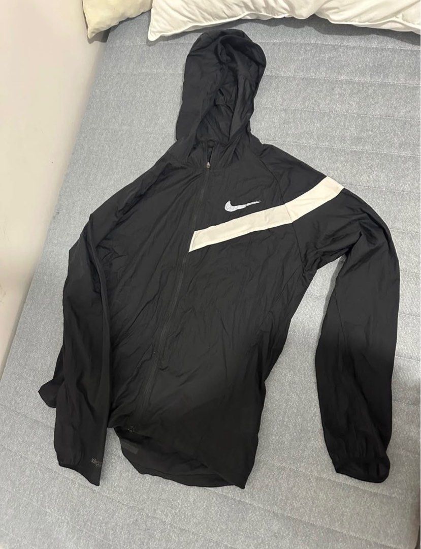 Nike Windbreaker Jacket (Category: Coats, Jackets and Outerwear) located in Cavite. Submitted by jca__ (Listing ID 1398453299, Image 1). Description: - Nike windbreaker jacket - Size: M (fits 165-175cm height) - Features: Hood, zipper, white diagonal stripe - Material: 100% nylon - Made in Vietnam - manipis, goods pamatong.