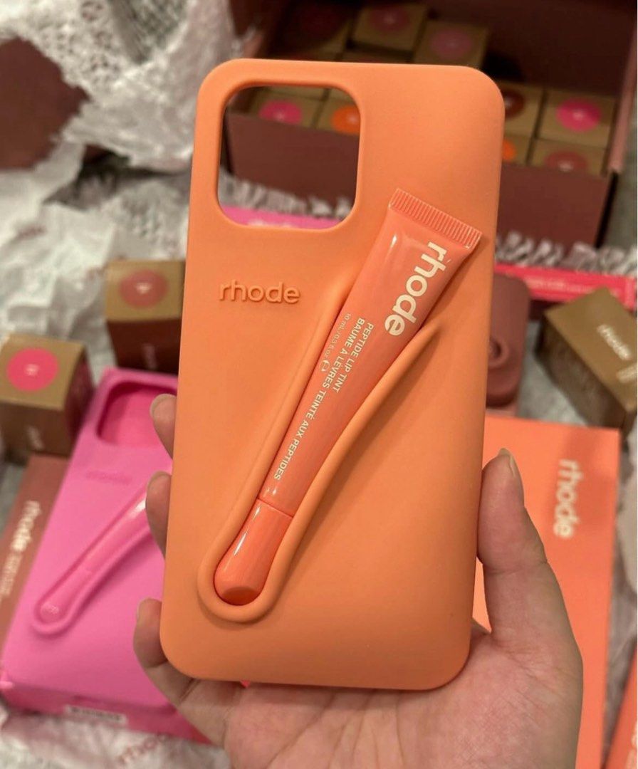 Rhode Iphone Case (Category: Cases & Sleeves) located in San Pedro. Submitted by hausoflux (Listing ID 1398445287, Image 2). Description: - Rhode iPhone Case - Available in colors (pink, orange, red, brown) - Features a built-in holder for Rhode Peptide Lip Tint - Stylish design - Protects your phone - Available in all iphone units 11 series up! authentic and brand new below SRP!!.