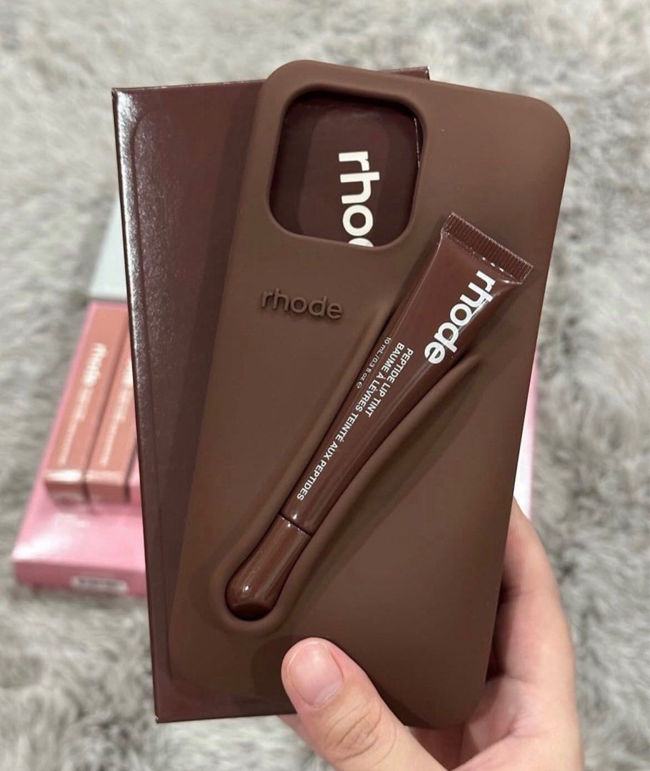Rhode Iphone Case (Category: Cases & Sleeves) located in San Pedro. Submitted by hausoflux (Listing ID 1398445287, Image 1). Description: - Rhode iPhone Case - Available in colors (pink, orange, red, brown) - Features a built-in holder for Rhode Peptide Lip Tint - Stylish design - Protects your phone - Available in all iphone units 11 series up! authentic and brand new below SRP!!.
