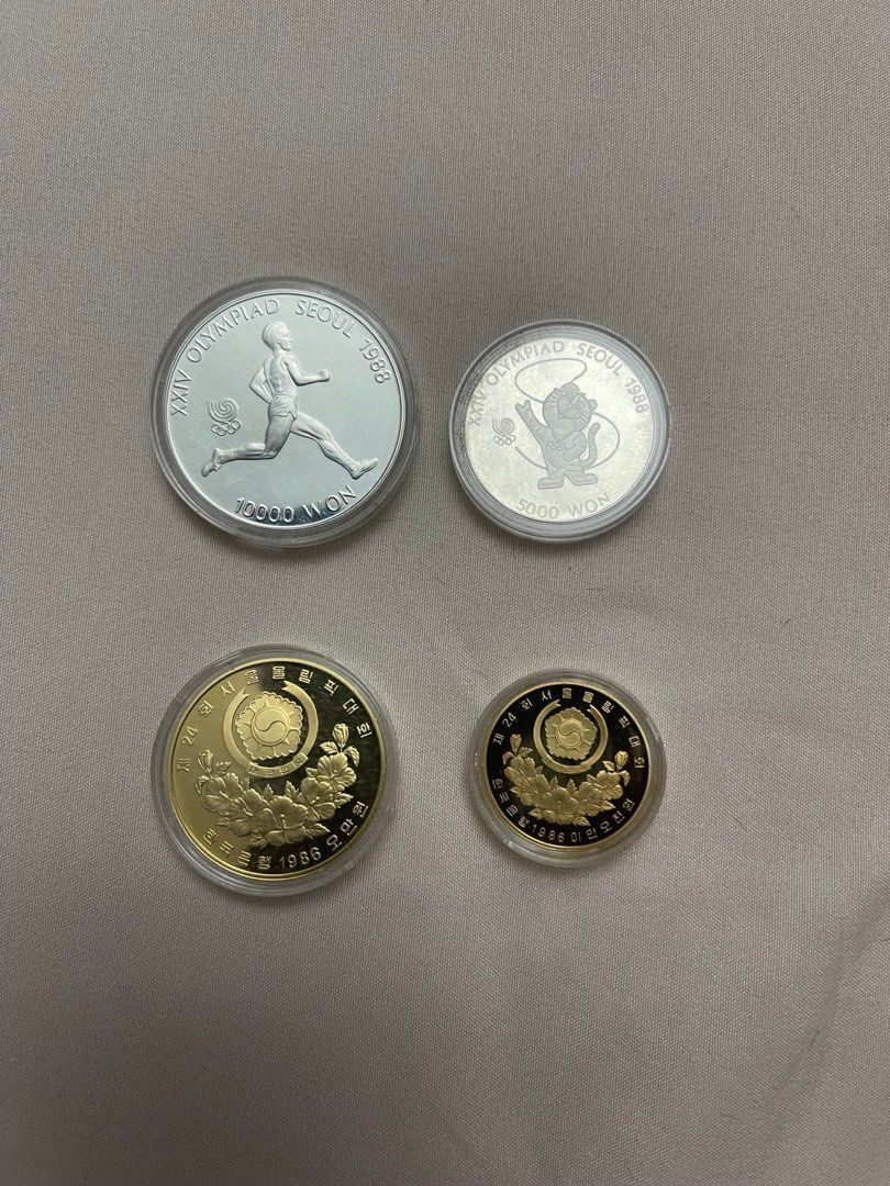Seoul 1988 Olympic Commemorative Coins (Category: Currency) located in Paranaque City. Submitted by patrickph31 (Listing ID 1398509454, Image 1). Description: - 1988 Seoul Olympics Commemorative Coins (Set of 4) - Includes: - Two silver coins (10000 WON and 5000 WON) - Two gold-colored coins 50000 WON and 25000 WON - Features Olympic-themed designs - Coins are in protective cases.