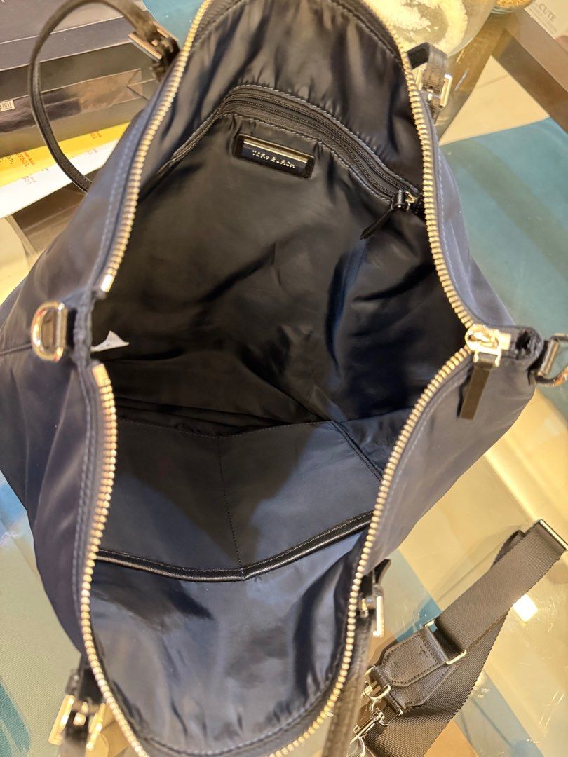 Tory Burch Nylon Tote Bag (Category: Luxury Bags & Wallets) located in Taguig. Submitted by superbshops.ph (Listing ID 1398420578, Image 2). Description: - used 1x only - Navy blue nylon exterior - Zip closure - Detachable shoulder strap - Dual top handles - Main compartment and small interior pocket - Tory Burch logo on front.