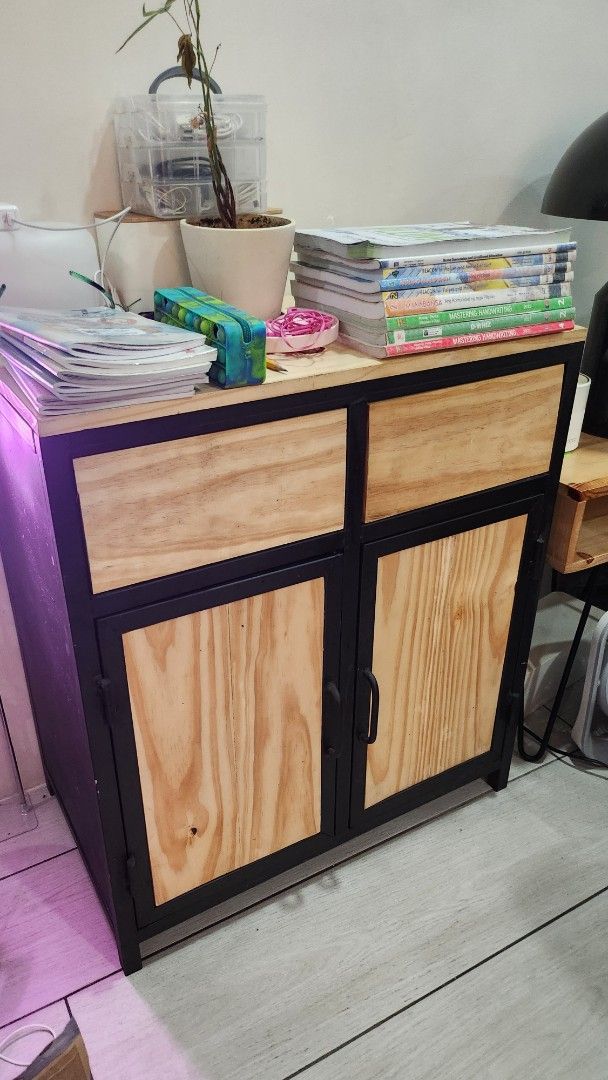 Wooden Storage Cabinet with Black Frame (Category: Shelves, Cabinets & Racks) located in Quezon City. Submitted by ishopph (Listing ID 1398351766, Image 1). Description: - Wooden storage cabinet real pine wood - Black frame - Two doors - Multiple compartments for storage - Sturdy construction - Ideal for home or office use - Provides ample storage space Condition: 8/10 Issue: slightly rough finish RFS: Upgrading FOR PICK UP ONLY! pm for other dee
