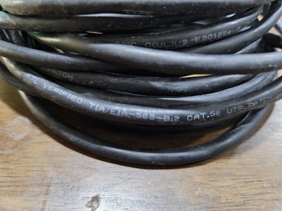 CAT5e UTP Patch Cable 7 (Category: Cables & Adaptors) located in Rawang. Submitted by dss79 (Listing ID 1398565357, Image 3). Description: - Black CAT5e UTP patch cable -7 meters - RJ45 connectors on both ends - Cable is coiled and secured with a green tie - Compliant with TIA/EIA-568-B.2 standards - Suitable for network connections.