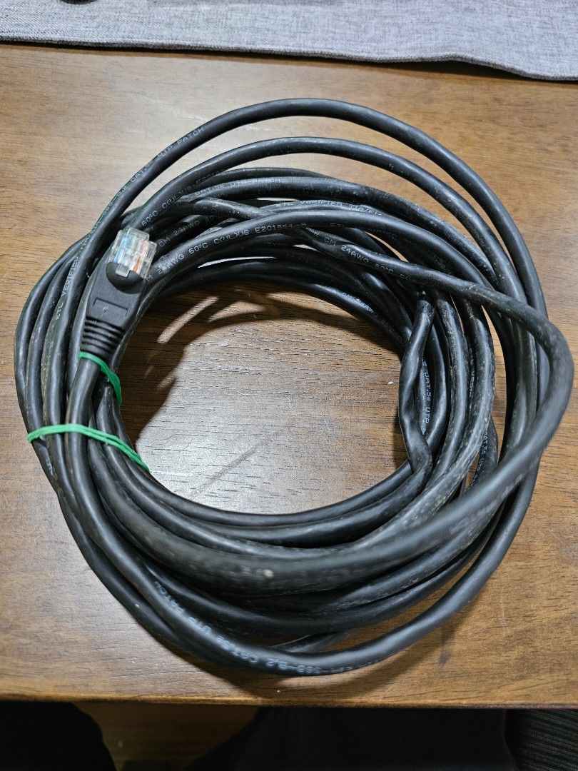 CAT5e UTP Patch Cable 7 (Category: Cables & Adaptors) located in Rawang. Submitted by dss79 (Listing ID 1398565357, Image 1). Description: - Black CAT5e UTP patch cable -7 meters - RJ45 connectors on both ends - Cable is coiled and secured with a green tie - Compliant with TIA/EIA-568-B.2 standards - Suitable for network connections.