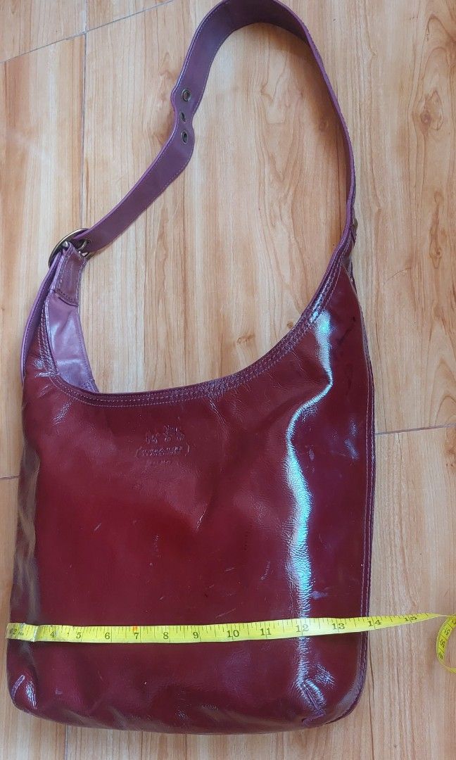 Coach Bleecker Delphine Patent Hobo bag (Category: Luxury Bags & Wallets) located in Davao. Submitted by wengbagstuff (Listing ID 1398558238, Image 3). Description: 🍀 patent x calfskin materials 🍀 mininal signs of usage since it's a preloved bag 🍀 zipper closure 🍀 w/ color transfer on one side 🍀 maroon & plum color combination 🍀 adjustable strap w/ 7 holes, can be kili bag or crossbody bag 🍀 14K on preloved retai.