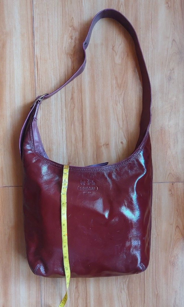 Coach Bleecker Delphine Patent Hobo bag (Category: Luxury Bags & Wallets) located in Davao. Submitted by wengbagstuff (Listing ID 1398558238, Image 2). Description: 🍀 patent x calfskin materials 🍀 mininal signs of usage since it's a preloved bag 🍀 zipper closure 🍀 w/ color transfer on one side 🍀 maroon & plum color combination 🍀 adjustable strap w/ 7 holes, can be kili bag or crossbody bag 🍀 14K on preloved retai.