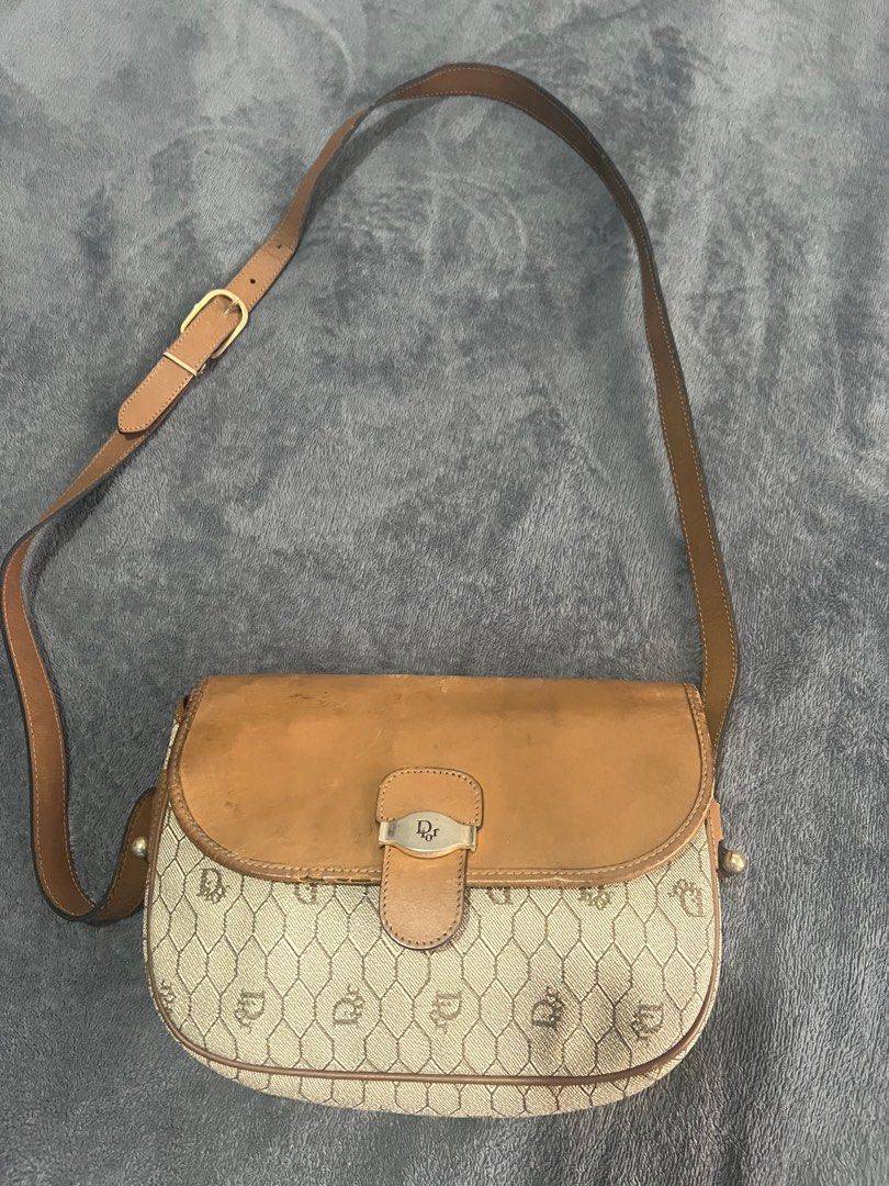 Dior Shoulder Bag (Category: Luxury Bags & Wallets) located in Quezon City. Submitted by kayesantos7 (Listing ID 1398543837, Image 3). Description: Super Sale!!! - Vintage Dior shoulder bag - Tan leather flap and strap - Dior logo clasp - Repeating Dior pattern on body - Matching fabric interior - Adjustable shoulder strap Selling my vintage Christian Dior honeycomb leather shoulder bag! Has signs of usage as seen on the photos. Still so timeless