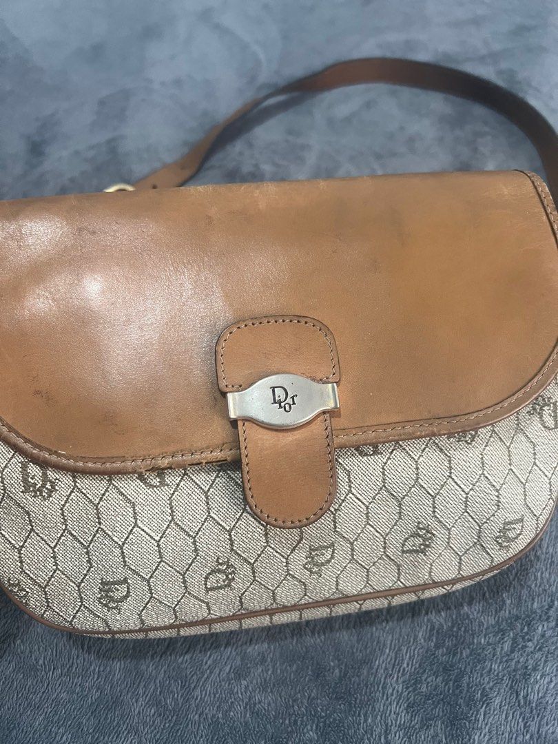Dior Shoulder Bag (Category: Luxury Bags & Wallets) located in Quezon City. Submitted by kayesantos7 (Listing ID 1398543837, Image 1). Description: Super Sale!!! - Vintage Dior shoulder bag - Tan leather flap and strap - Dior logo clasp - Repeating Dior pattern on body - Matching fabric interior - Adjustable shoulder strap Selling my vintage Christian Dior honeycomb leather shoulder bag! Has signs of usage as seen on the photos. Still so timeless