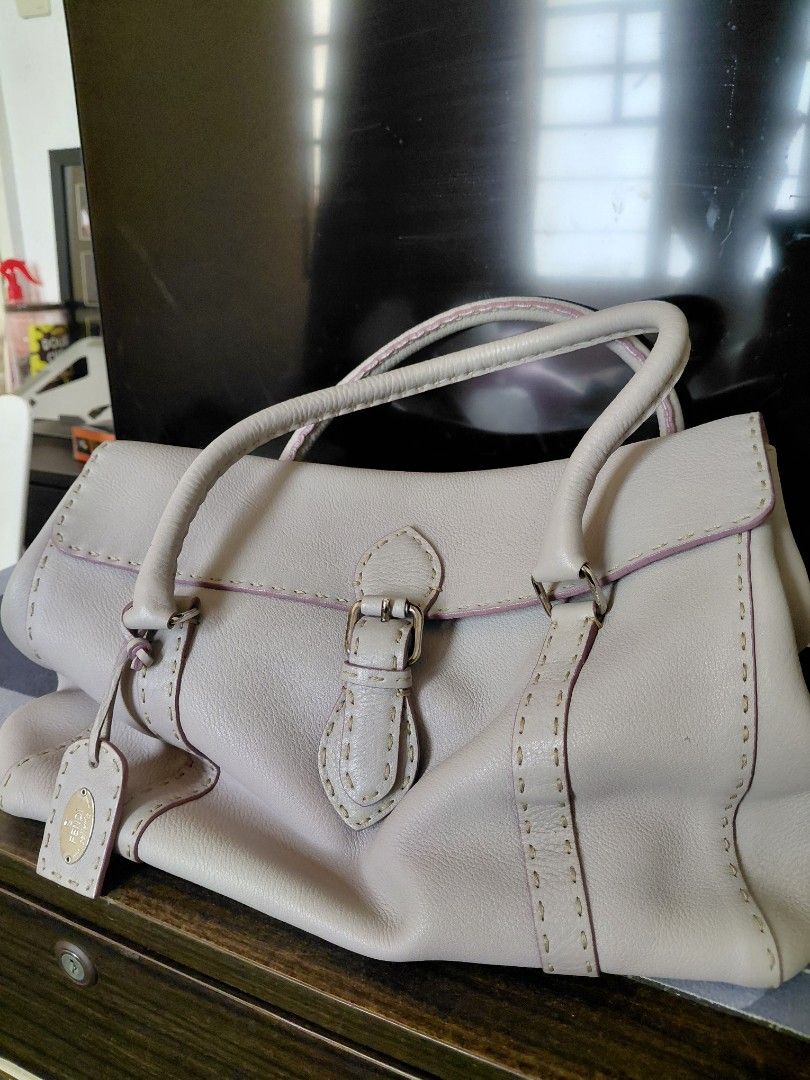 Authentic Fendi Leather Handbag (Category: Luxury Bags & Wallets) located in Pasig City. Submitted by redellie (Listing ID 1398596281, Image 1). Description: - Fendi handbag in a light purple color - Features a top handle design - Secure buckle closure - Interior includes a branded metal plate - Structured shape with visible stitching - Includes a small brand logo tag Linda Selleria (large) no inclusions. open for layaway (terms: 3months no addit