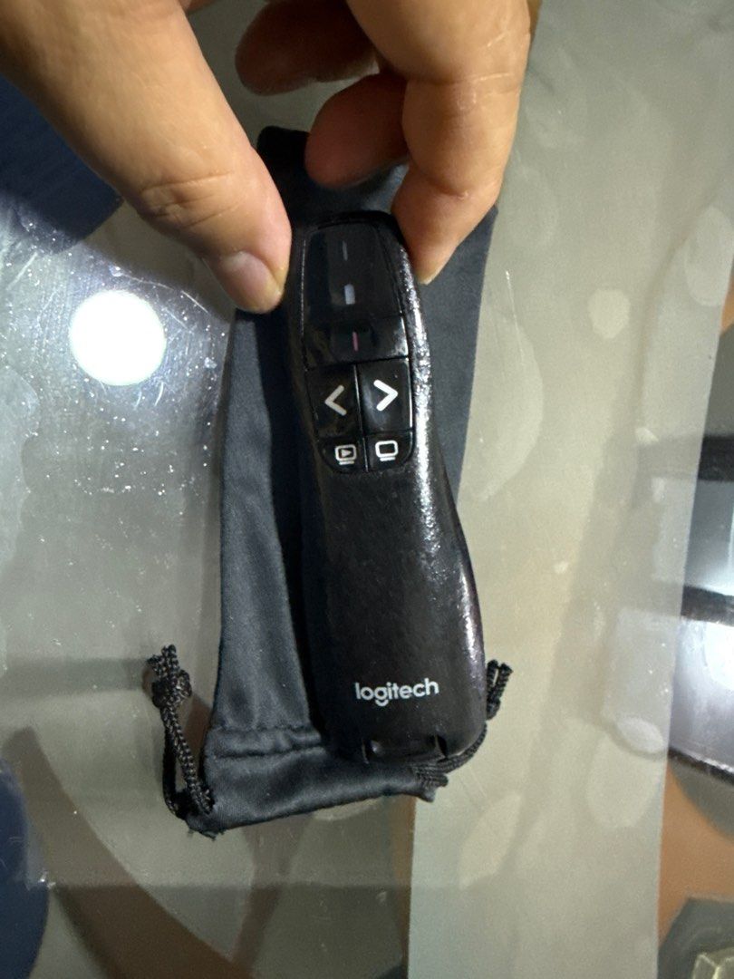Logitech Presenter with Laser Pointer (Category: Other Accessories) located in Singapore. Submitted by madchineserabbit (Listing ID 1398698878, Image 1). Description: - Includes presenter, USB receiver, and carrying pouch - Features: - Forward/back buttons - Laser pointer - Blank screen button - Perfect for presentations!.