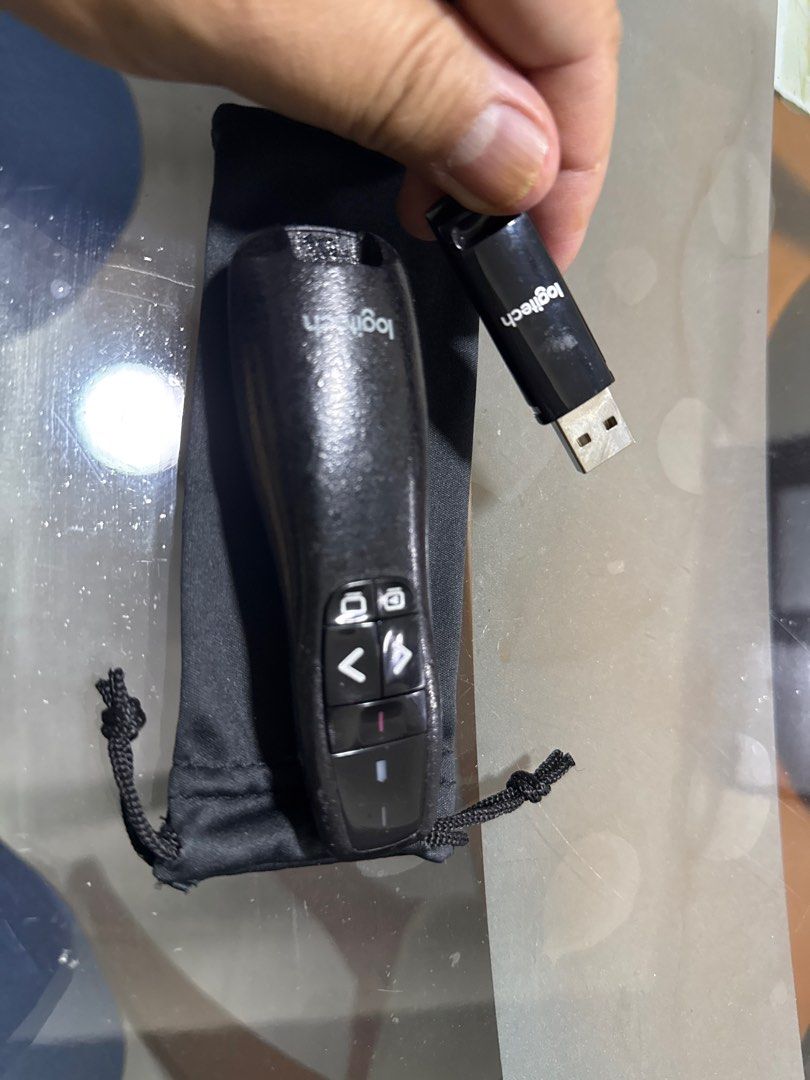 Logitech Presenter with Laser Pointer (Category: Other Accessories) located in Singapore. Submitted by madchineserabbit (Listing ID 1398698878, Image 3). Description: - Includes presenter, USB receiver, and carrying pouch - Features: - Forward/back buttons - Laser pointer - Blank screen button - Perfect for presentations!.