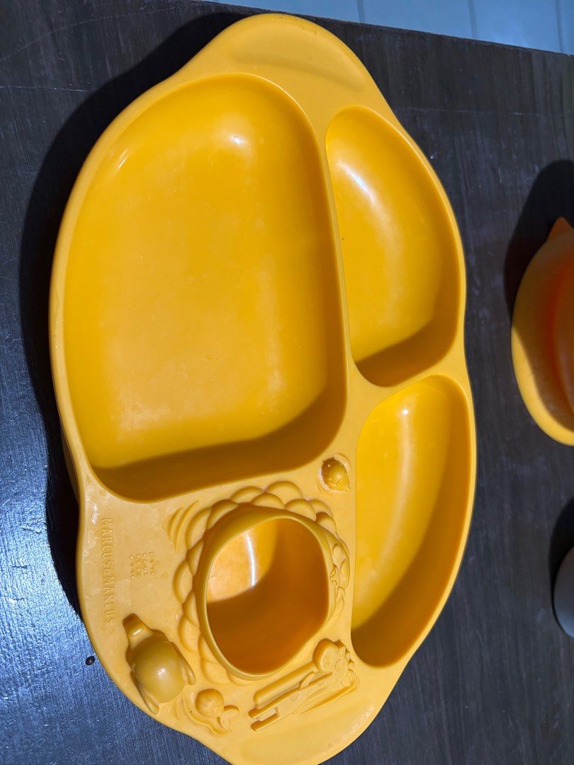 Marcus & Marcus Baby Feeding Set with Hoshi Silicon Cup (Category: Weaning & Toddler Feeding) located in Tagaytay City. Submitted by bullet__ (Listing ID 1398696041, Image 2). Description: - Marcus & Marcus baby feeding set - Includes a divided plate with animal designs - Plate has sections for different food types - Includes a separate bowl with handles - Made of yellow material - Easy grip bowl With Hoshi silicon cup.
