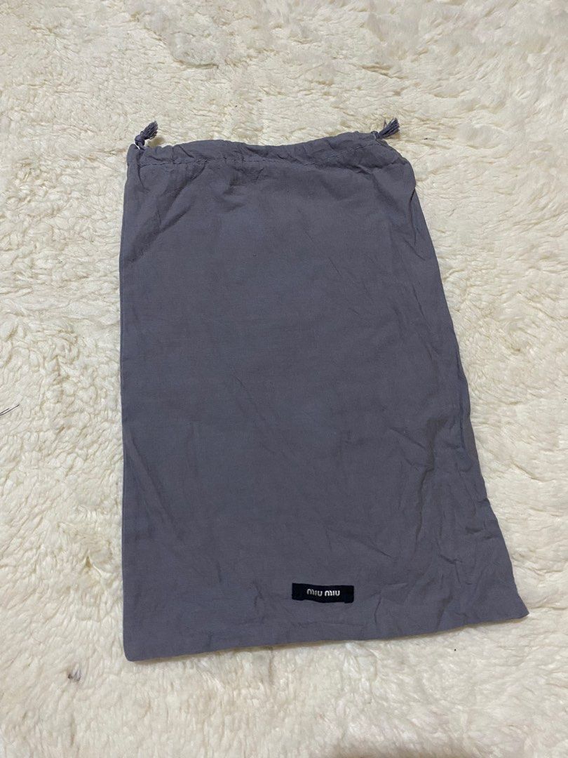 (5% off) ❤️ Miu Miu Dust Bag (Category: Luxury Bags & Wallets) located in Manila. Submitted by avathriftedcloset (Listing ID 1398638363, Image 1). Description: - Authentic Miu Miu dust bag - Gray drawstring bag - Features the Miu Miu logo - Made of soft, lightweight material - Ideal for protecting your Miu Miu items.