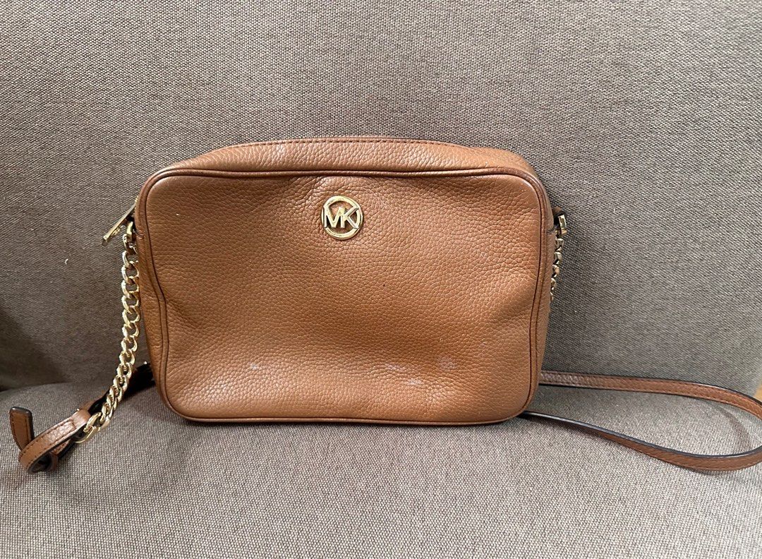 MK sling bag (Category: Cross-body Bags) located in Pasig City. Submitted by chubby_cheeks (Listing ID 1398555908, Image 1). Description: With few light stains, check photos .
