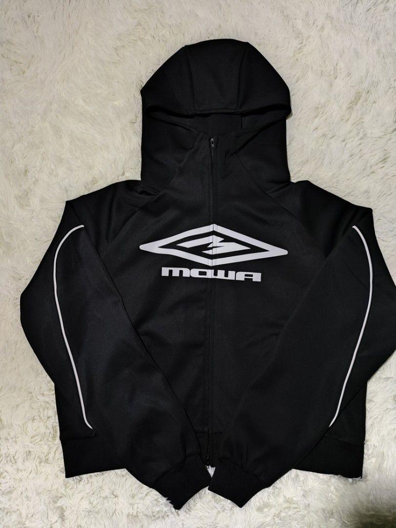 Mowalola Black Hoodie Jacket (Category: Coats, Jackets and Outerwear) located in Caloocan City. Submitted by 808akali (Listing ID 1398675976, Image 1). Description: Black hoodie jacket from Mowalola. Features a full zip closure, hood, and white accents along the sleeves. The Mowalola logo is prominently displayed on the front. The jacket is size S and made of a polyester and spandex blend. The jacket has a ribbed hem and cuffs..