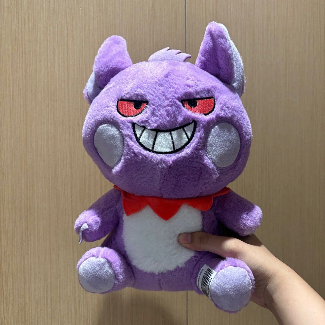 Pokemon Gengar Plush Toy (Category: Plushies & Soft Toys) located in Manila. Submitted by kfgin (Listing ID 1398634958, Image 1). Description: - Adorable Gengar plush toy. - Features Gengar's signature purple color and red eyes. - Has a mischievous grin. - Includes a red collar and white belly. - Soft and huggable. - Perfect gift for Pokemon fans or collectors..