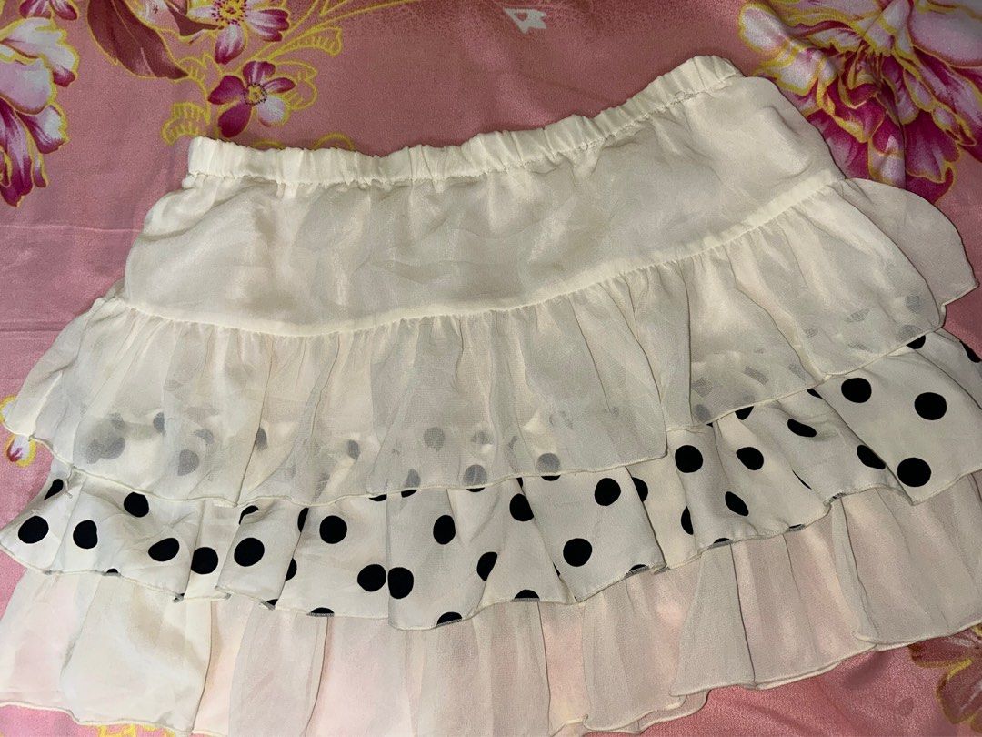 Polka Dot Ruffle Skirt (Category: Skirts) located in Davao. Submitted by declutterstuff01 (Listing ID 1398693059, Image 1). Description: - Unique design with alternating solid and polka dot fabric - Ruffled hem - Elastic waistband - Light color (off-white/cream) - Lightweight material - Versatile for various outfits.