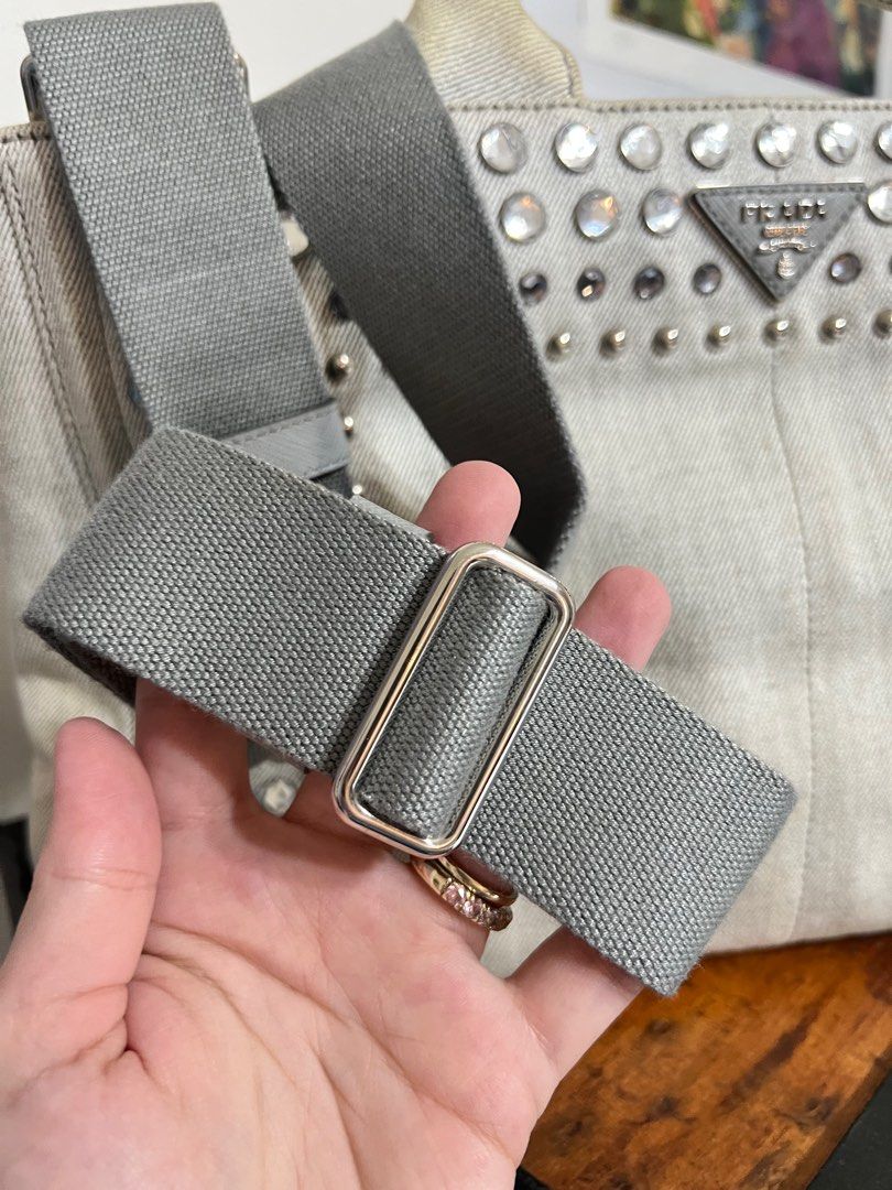 Prada Bijoux Denim Studded Bag Gray (Category: Luxury Bags & Wallets) located in Marikina City. Submitted by bg22.23 (Listing ID 1398526531, Image 3). Description: - Prada tote bag - With white tag - Light gray canvas material - Silver-tone studs - Top handle and detachable shoulder strap - Medium size - Prada logo visible - Suitable for everyday use - With discolorations, hence the price. - Physically bought from Japan myself. Auth! - All availa