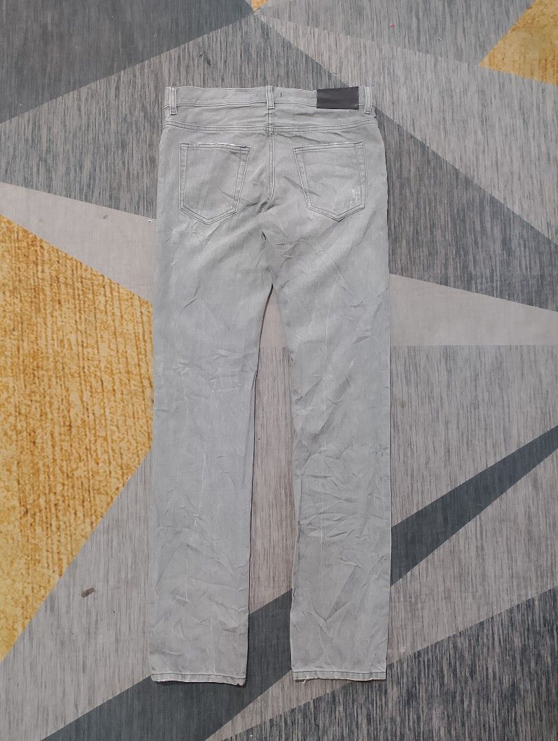 Prada Tight Fit Jeans (Category: Luxury Apparel) located in Santiago. Submitted by dc_daily_thrift (Listing ID 1398699432, Image 2). Description: - Prada Tight Fit jeans - Color: Grey - Size: 29 on tag 32 on measuring tape - Features: Button closure with Prada logo, classic five-pocket design, straight leg fit - Details: Prada logo on back leather patch and inside tag - Made in Romania.
