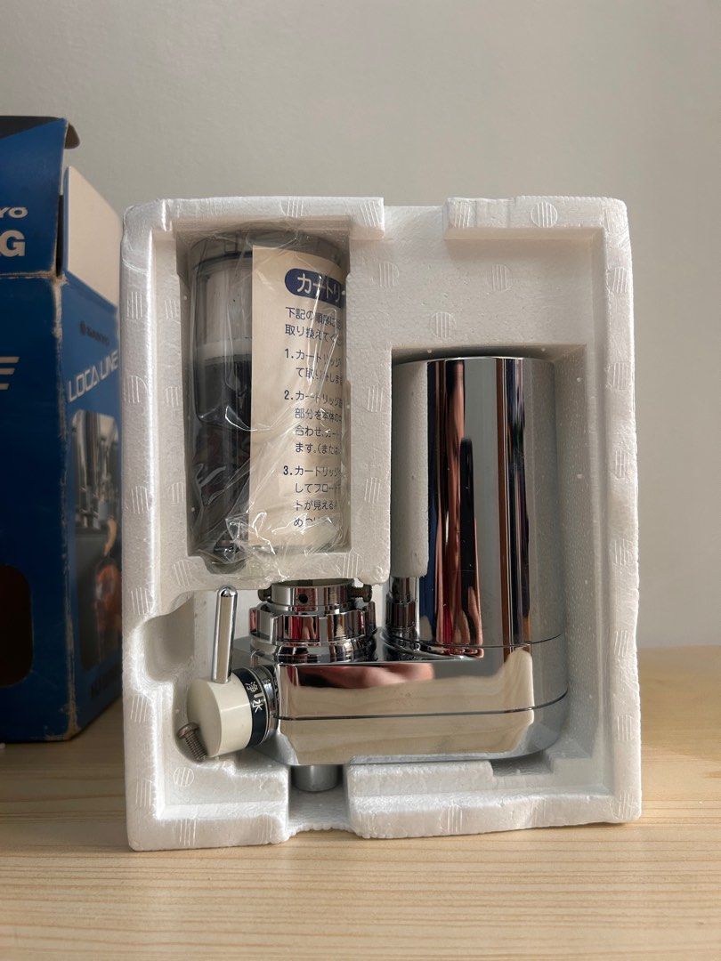 Sanyo HJ-20AG Water Purifier with Filter (Category: Water Purifiers & Dispensers) located in Manila. Submitted by mecrafts4u.olstr (Listing ID 1398654162, Image 3). Description: Sanyo HJ-20AG water filter. The box includes the water filter unit, a filter cartridge, and an instruction manual. The filter is designed to be installed on a faucet. The box shows the filter's features, including the ability to filter water and a flow indicator..