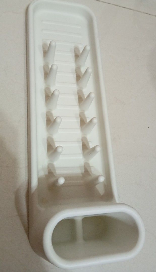 White Dish Drying Rack (Category: Other Kitchenware & Tableware) located in San Juan City. Submitted by maias.secret (Listing ID 1398669426, Image 2). Description: - White dish drying rack - Features pegs for plates and glasses - Rectangular design with raised edges - Durable material - Perfect for countertop use - Space-saving kitchen solution - Reason for Selling,not needed. -I bought this to IKEA but no space na pala. - Thanks and God bless yo