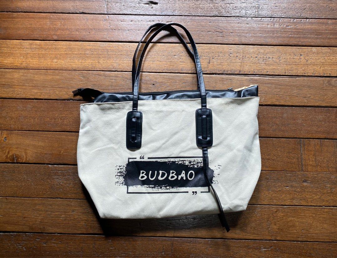 BUDBAO Canvas Tote Bag with Zipper (Category: Tote Bags) located in Quezon. Submitted by ojfinds (Listing ID 1398725700, Image 1). Description: ‼️FOR SALE‼️ BUDBAO Canvas Tote Bag with Zipper - Canvas exterior - Black accents and handles - Zippered main compartment - Interior pocket - Printed logo - Black, leather-like handles - Light tan interior lining.