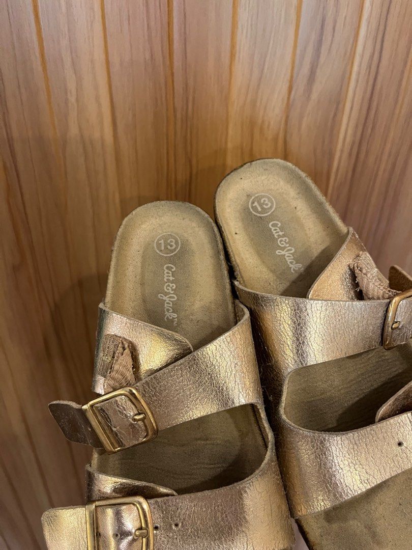 Cat & Jack Gold Sandals Size 13 (Category: Babies & Kids Fashion) located in Paniqui. Submitted by krestetaaa (Listing ID 1398860338, Image 2). Description: - Cat & Jack gold sandals - Size 13 - Two adjustable straps with buckles - Cork-like footbed - Textured soles for grip - Ideal for casual wear.