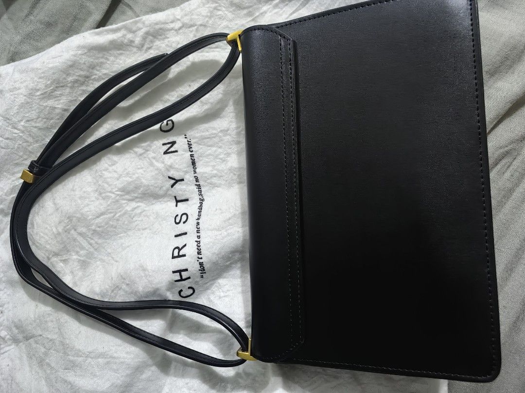 Christy Ng mauve shoulder bag (Category: Cross-body Bags) located in Mandaluyong City. Submitted by midnight_28 (Listing ID 1398849982, Image 2). Description: - Christy Ng crossbody bag in black - Flap closure with gold logo - Adjustable long strap - Includes dust bag - Made of smooth leather or leather-like material - Minimalist design - Perfect for various occasions.