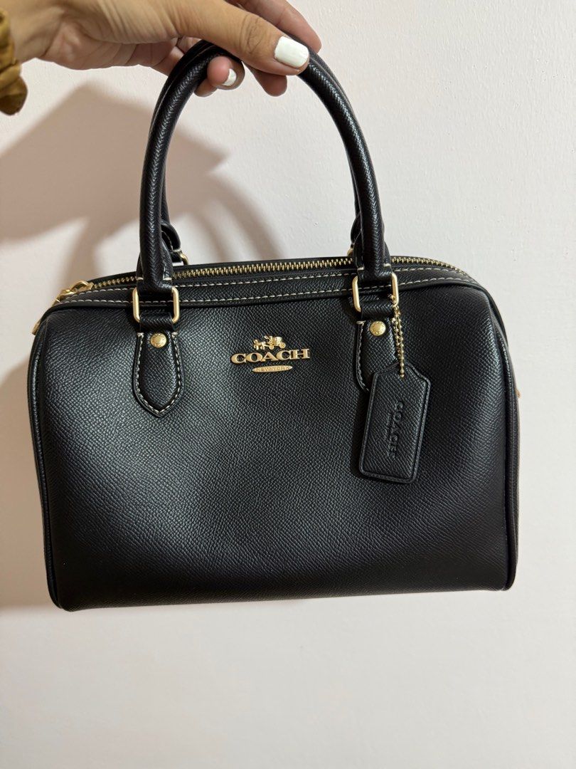 Coach Mini Satchel Bag / Coach Rowan (Category: Luxury Bags & Wallets) located in Manila. Submitted by zapglnwn (Listing ID 1398864410, Image 1). Description: - Black Coach mini satchel - Gold-tone hardware - Top zip closure - Dual top handles - Adjustable, detachable shoulder strap - Coach hang tag - Back zip pocket - Interior slip pocket - Contrasting white stitching not guaranteed authentic, bought in IG for ₱5,000 - used twice only.