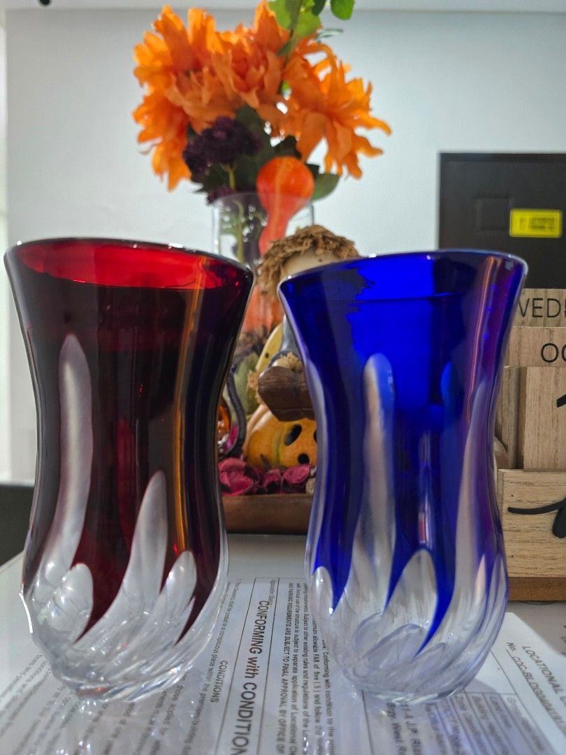 Colored Glass Vases (Category: Vases & Decorative Bowls) located in Taguig. Submitted by threadsntable (Listing ID 1398811188, Image 2). Description: - Set of two glass vases - One blue, one red - Unique swirling design - Flared top and sturdy base - Ideal for flowers or decoration.