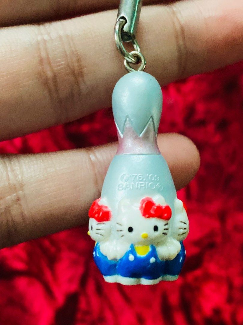 Hello Kitty Round 1 Bowling Pin Keychain 250 (Category: Character Goods) located in Zamboanga. Submitted by kawaii_omocha_est2020 (Listing ID 1398823873, Image 1). Description: - Adorable Kitty bowling pin keychain. - Features a silver top and blue base. - Decorated with Kitty faces. - Marked with 'Round 1' and the Sanrio logo. - Comes with a black strap for easy attachment. ✅Mine now/ Pay now ✅ Please scan all photos for more details. ✅ Manage y