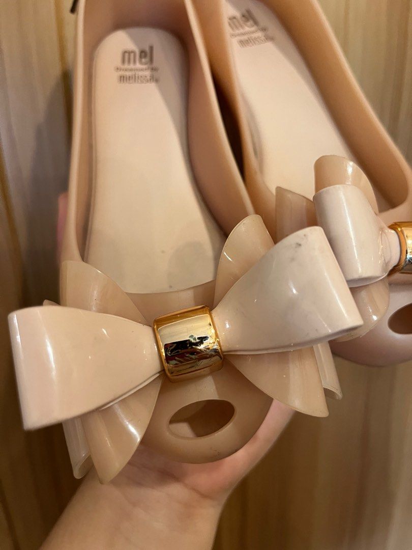 Mini Melissa Bow Shoes (Category: Babies & Kids Fashion) located in Paniqui. Submitted by krestetaaa (Listing ID 1398860308, Image 2). Description: - Nude flats - Bow detail with gold-colored accent - Melissa branded soles - Made of a rubbery material - Strong yummy scent.