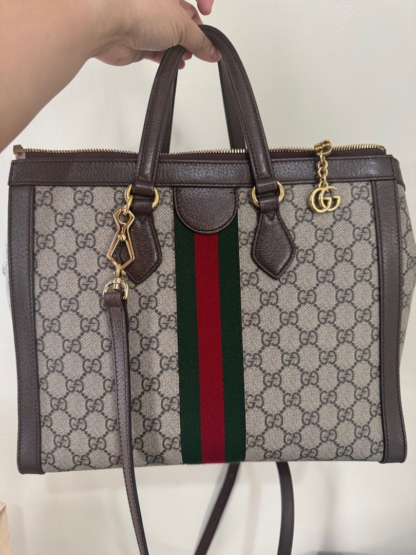 Gucci Ophidia Large Tote Bag (Category: Luxury Bags & Wallets) located in Mandaue City. Submitted by OCgirlscloset (Listing ID 1398869801, Image 2). Description: - Authentic Gucci tote bag - Crafted from iconic GG Supreme canvas - Features brown leather trim and handles - Structured tote bag design - Includes a shoulder strap.