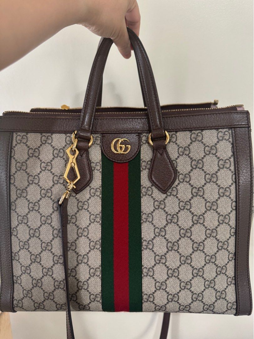 Gucci Ophidia Large Tote Bag (Category: Luxury Bags & Wallets) located in Mandaue City. Submitted by OCgirlscloset (Listing ID 1398869801, Image 1). Description: - Authentic Gucci tote bag - Crafted from iconic GG Supreme canvas - Features brown leather trim and handles - Structured tote bag design - Includes a shoulder strap.