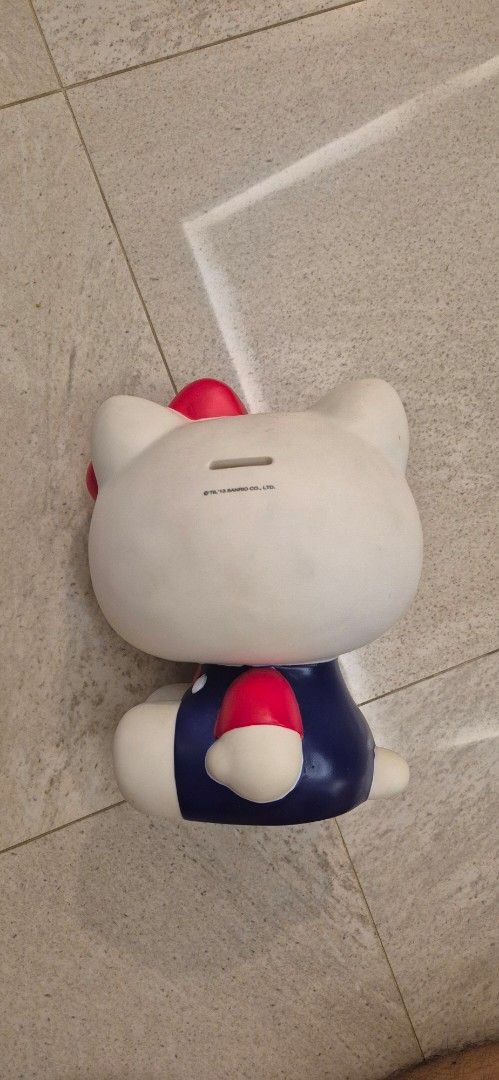 Hello Kitty Sanrio Piggy Bank (Category: Character Goods) located in Taguig. Submitted by ipsagar (Listing ID 1398872996, Image 2). Description: - Unique design: mustache outfit - Coin slot on the back - Perfect for Kitty collectors - needs a bit of cleaning only.