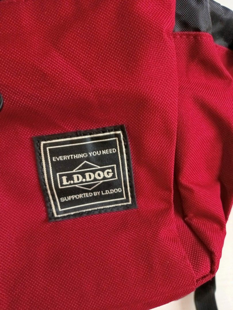 L.D. DOG Pet Carrier Backpack - Size M (Category: Homes & Other Pet Accessories) located in Quezon City. Submitted by catsdeclutter (Listing ID 1398956108, Image 2). Description: - L.D. DOG pet carrier backpack - Color: Red and Black - Size: M (marked inside) - Features: - Mesh side panel for ventilation - Multiple straps for secure carrying - Pocket with L.D. DOG logo - Includes: Clip and small orange buckle.