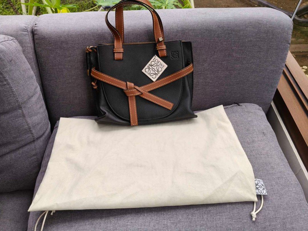 Loewe Gate Small Bag Black and Tan (Category: Luxury Bags & Wallets) located in Muntinlupa City. Submitted by momofsix925 (Listing ID 1398967563, Image 2). Description: - Brand new Loewe Gate Small Bag - Black and tan leather - Knotted front detail - Top handles - Detachable shoulder strap - Interior zipped pocket - Includes dust bag and tags - Structured shape - Classic design.