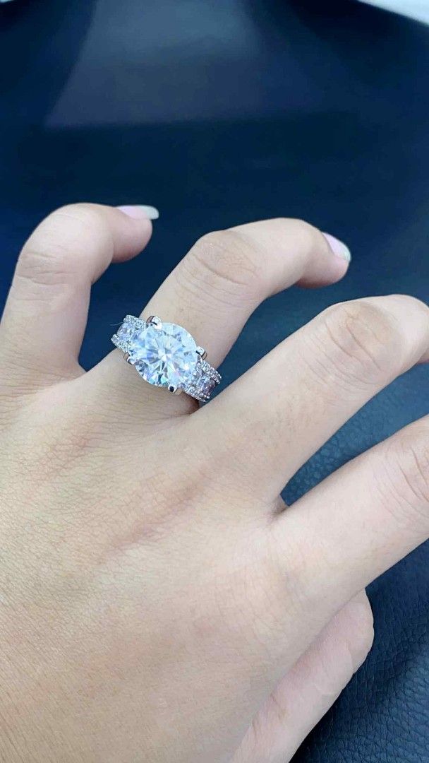 Moissanite 5ct Engagement/ Proposal ring (Category: Rings) located in Manila. Submitted by szairajewel (Listing ID 1399047034, Image 1). Description: Engagement ring with Moissanite stone positive to diamond tester clarity VVS1 and color grade Excellent flawless. The ring has a silver band dip in white gold . It is a beautiful piece that would make a great addition to any jewelry collection. The ring is designed with a classic and elegant style..