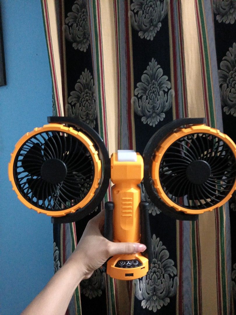 Portable Dual Camping Fan with LED Light (Category: Fans) located in Daraga. Submitted by declutter.with_me (Listing ID 1399010179, Image 1). Description: REPRICED FROM 1,550 OG PRICE 2K+ - Portable fan with dual fans - Integrated LED light - Includes a stable tripod and hook - Stylish orange and black color scheme - Easy-grip handle - Convenient button controls - Designed for portability.